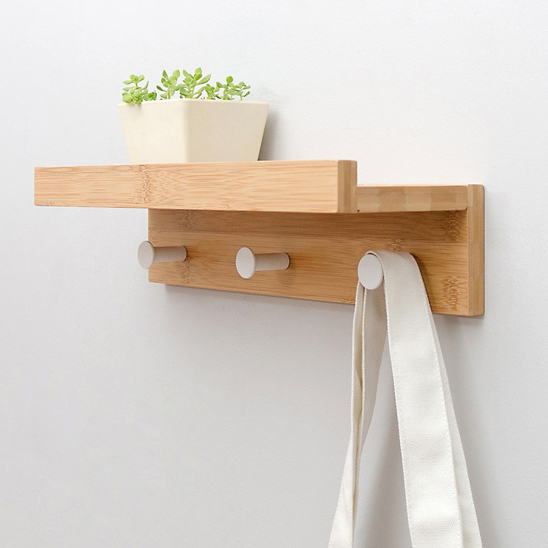 white wooden wall shelf with hooks